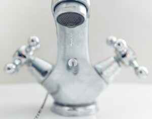Image of water dripping out of a bathroom faucet.
