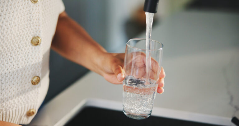 woman filling glass of water